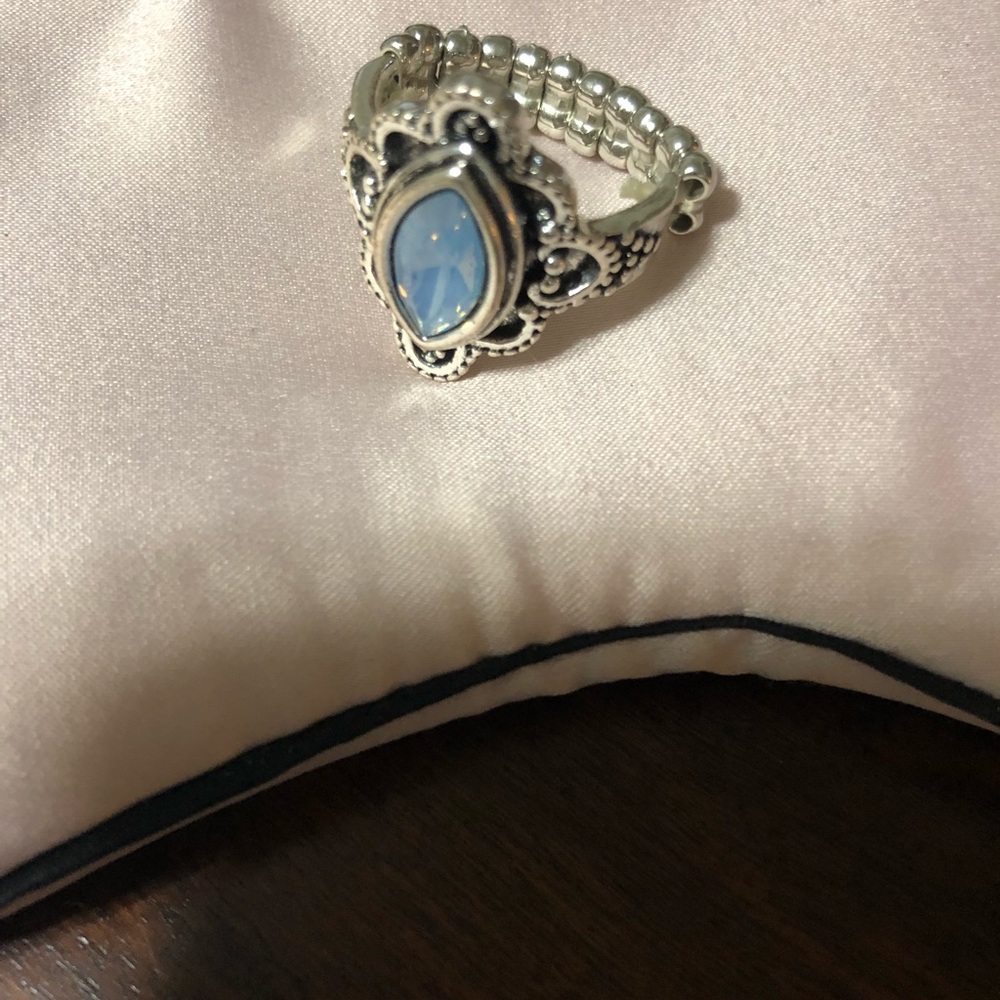 Blue stone silver tone stretch ring.